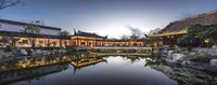 an asian courtyard is shown with water lils and lights in it at night time