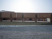 there is a courtyard with trees on it and buildings in the background of the image