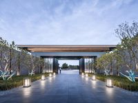 a courtyard with trees on both sides and lights on each side and a large walkway