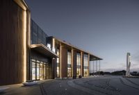 the facade of the museum at dusk with leds and steps leading up to it