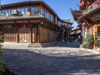 the entrance way to a large asian style city with wooden accents and windows that are set in bricks