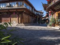 the entrance way to a large asian style city with wooden accents and windows that are set in bricks