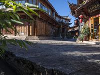 the entrance way to a large asian style city with wooden accents and windows that are set in bricks