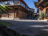 the entrance way to a large asian style city with wooden accents and windows that are set in bricks