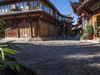 the entrance way to a large asian style city with wooden accents and windows that are set in bricks