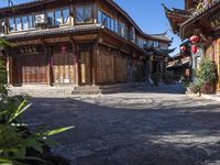 the entrance way to a large asian style city with wooden accents and windows that are set in bricks