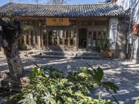 a restaurant with some trees and brick walkways in front of it at the back