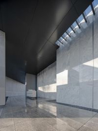 a large glass wall and marble floors inside of a building that's almost made out of white marble