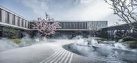 a building with a large garden and two courtyards with water fountains and a tree