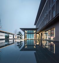 the reflection is seen on the floor in a pool, which is reflecting the building