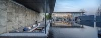 the swimming area with the concrete walls is reflecting the water and boats docked below it