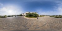 a 360 - view photo of a circular courtyard in the day time with many clouds