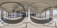 a 360 - shot looking down at a circular room filled with different sized furniture and large windows