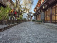 a walkway of some kind in a city alley with stone pavement and bamboo - like wood