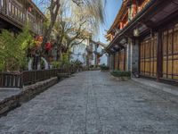 a walkway of some kind in a city alley with stone pavement and bamboo - like wood