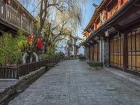 a walkway of some kind in a city alley with stone pavement and bamboo - like wood