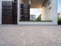 two tall dark brown metal tanks sitting next to a building with windows on top of each