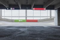 the parking garage with painted walls and painted arrows points to different directions on either side