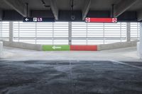 the parking garage with painted walls and painted arrows points to different directions on either side