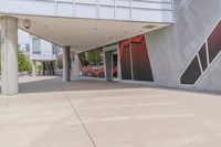 an outside picture of a building with windows and large red design on it to the side