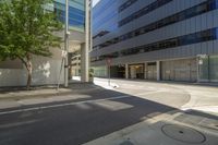 a sidewalk and street with many buildings in it in the city and at the intersection