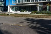 a man is riding his motorcycle down the road in front of a building with a balcony on it