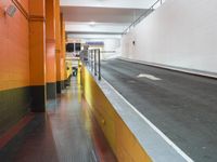 an empty long hallway with lots of parking and a sign in the middle of the space