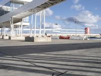 an airport with a jetliner and other airplanes in the sky behind a tall white structure