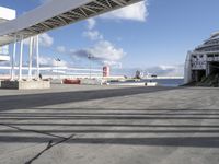 an airport with a jetliner and other airplanes in the sky behind a tall white structure