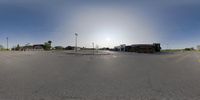 a 360 - eye view of a city area with sun in the background with buildings and traffic lights