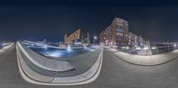 this is a 360 - view of the city at night from the top of a ramp