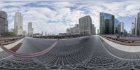 a view of the city through a fish - eye lens lens lens of a curved bridge