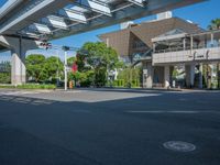 the city of richmond has long white arrows running down it's side and a pedestrian crossing over an expressway