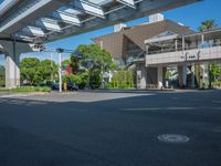 the city of richmond has long white arrows running down it's side and a pedestrian crossing over an expressway