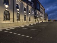 there is a parking lot outside the building at night time is empty, and empty but no people can use it