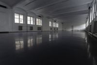 a room filled with windows and floors in an empty building with a dark gray floor