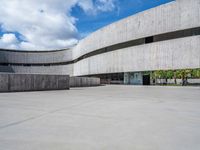 the building has been constructed into a concrete structure with several openings and curved walls and doors on either side