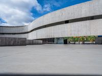 the building has been constructed into a concrete structure with several openings and curved walls and doors on either side