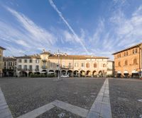 this is a street with several buildings on one side and other end and sky on the other