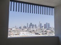 a city skyline with skyscrapers behind it and cars parked below the buildings on the lot