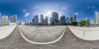 a 360 - view view of city buildings with a ramp in front of them and a person on a skateboard