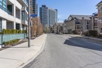 the residential area is very quiet, with houses lining both sides of the street in the distance