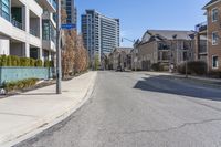 the residential area is very quiet, with houses lining both sides of the street in the distance