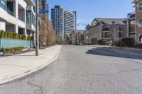 the residential area is very quiet, with houses lining both sides of the street in the distance