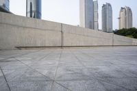 a large gray building with some concrete walls and a closed door in it's center