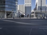 there is a person walking on the street in the daytime sun in the city center