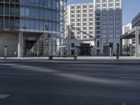 there is a person walking on the street in the daytime sun in the city center