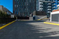 a lone fire hydrant in an empty parking lot area of a city center and business district