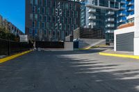 a lone fire hydrant in an empty parking lot area of a city center and business district