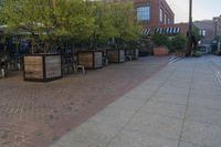 the courtyard with tree in front and small seatings in the front area on the sidewalk